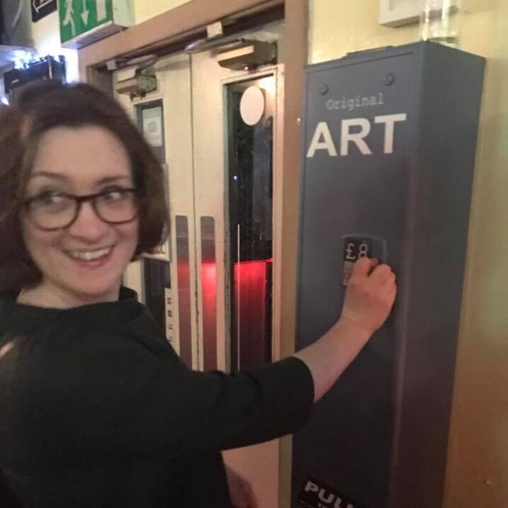 Lady using art vending machine artobotic